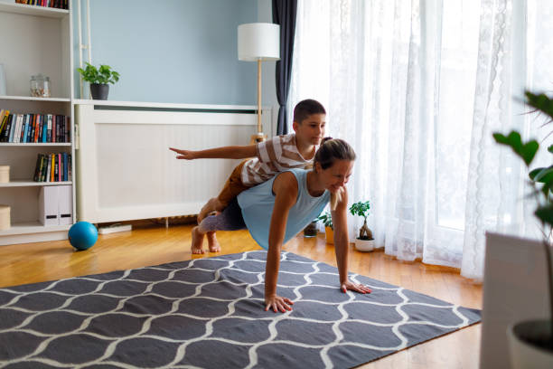 istock Mother And Son Performing Plank Pose 1413858815