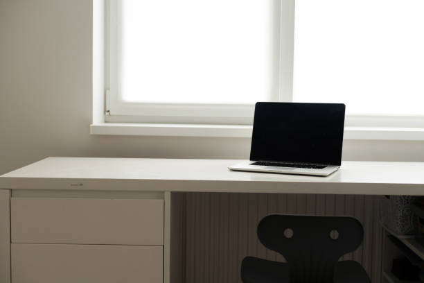 istock Horizontal photo of minimal workplace with computer laptop on white desk. 1413859117