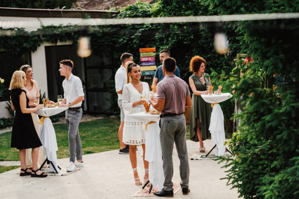 istock Multiracial couple drinking wine on garden party 1413859710