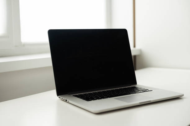 istock modern workspace with blank screen laptop on white table with white wall background 1413859722