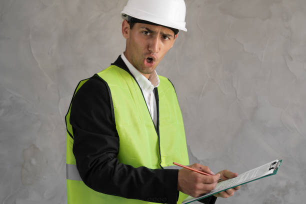 istock Angry muslim worker, Inspector or engineer is checking and inspecting the building or house by using checklist. An engineer man making notes on his clipboard in a factory. Industry 1413860303