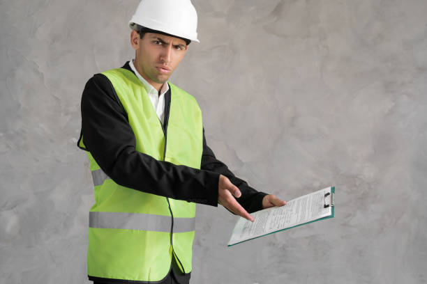 istock Muslim young architect inspector man wearing builder safety helmet and using clipboard annoyed and frustrated shouting with anger, crazy and yelling, anger 1413860312