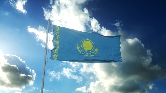 Flag of Kazakhstan waving at wind against beautiful blue sky. 3d illustration.