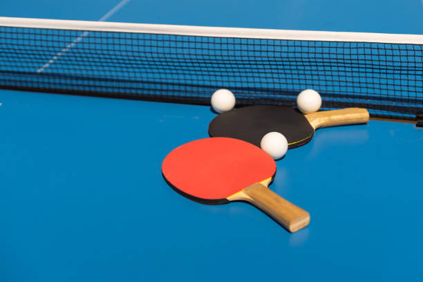 istock Ping pong table, rackets and balls in a sport hall. 1413861245