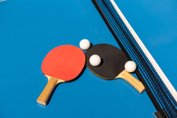 istock Ping pong table, rackets and balls in a sport hall. 1413861386