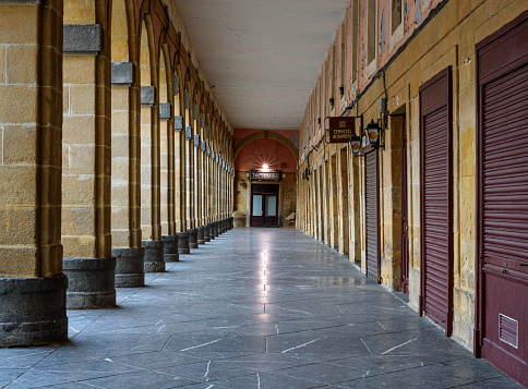 arcade of the plaza de la Constitución in San Sebastián deserted and clean on a cold winter morning.