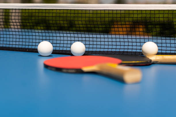 istock Ping pong table, rackets and balls in a sport hall. 1413861421