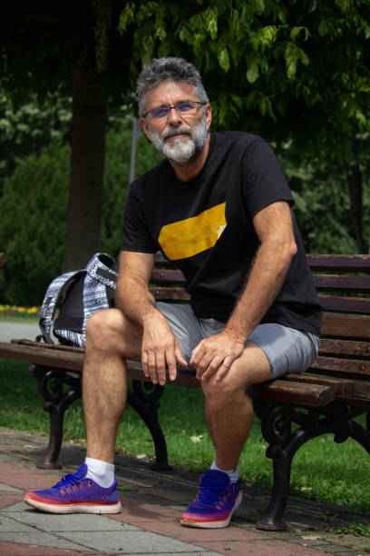 istock Senior man enjoy on bench in public park 1413861878