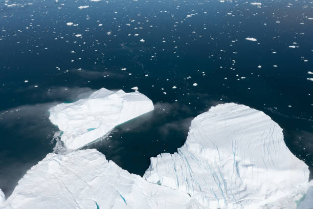 istock Climate change and global warming. Icebergs from a melting glacier in Greenland. 1413865390