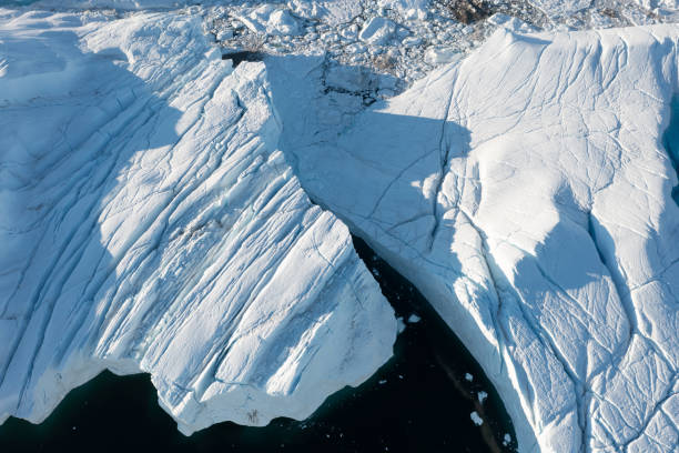 istock Climate change and global warming. Icebergs from a melting glacier in Greenland. 1413866636