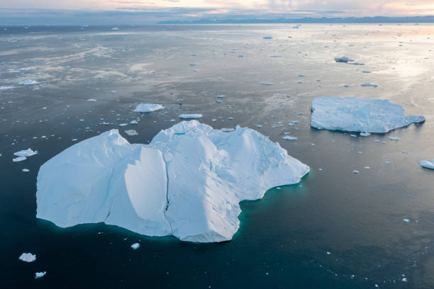 istock Climate change and global warming. Icebergs from a melting glacier in Greenland. 1413867401