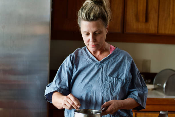 istock Woman with Scrubs cooking 1413867520