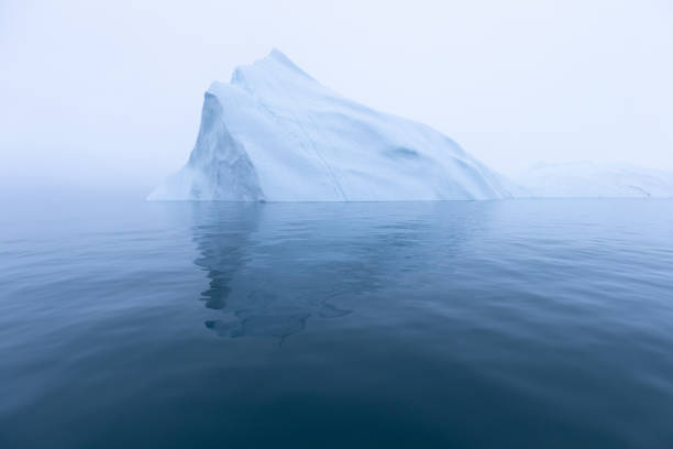 istock Climate change and global warming. Icebergs from a melting glacier in Greenland. 1413868531