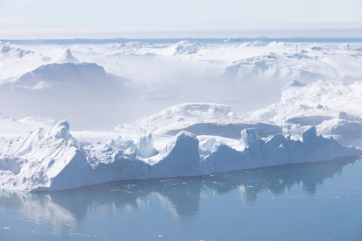 Climate change and global warming. Icebergs from a melting glacier in Ilulissat Glacier, Greenland. The icy landscape of the Arctic nature in the UNESCO world heritage site.