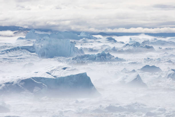 istock Climate change and global warming. Icebergs from a melting glacier in Greenland. 1413869691