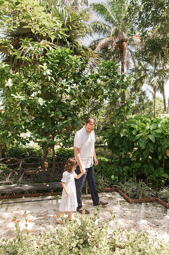 31-Year-Old Father Walking in a Tropical Garden in Palm Beach, Florida With His Toddler Daughter