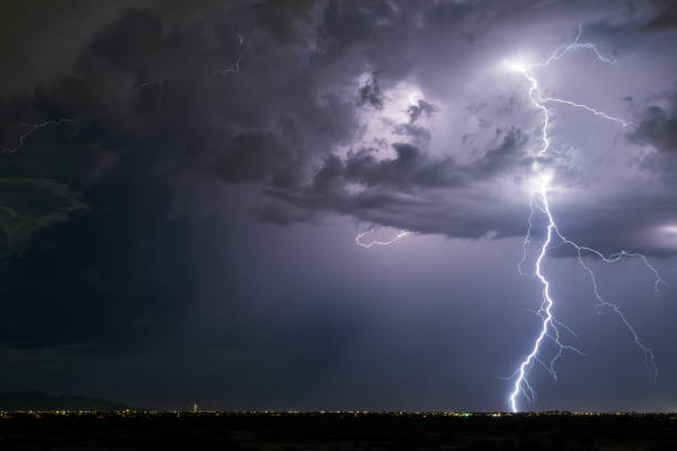 Lightning strike in a thunderstorm Powerful lightning strike from a monsoon thunderstorm in Arizona. storm stock pictures, royalty-free photos & images