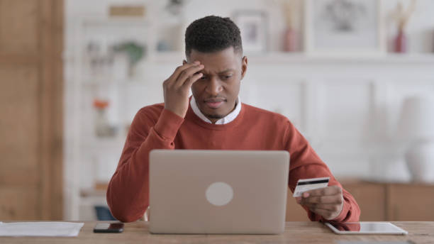 istock African Man making Online Payment Failure on Laptop in Office 1413878831