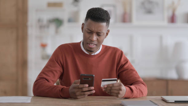 istock African Man Unsuccessful Online Payment on Smartphone 1413879897