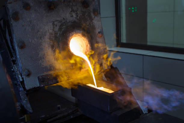 istock Pouring hot liquid gold into molds. 1413880102