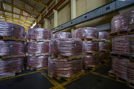 Coils of rolled copper wire. View of warehouse copper foundy