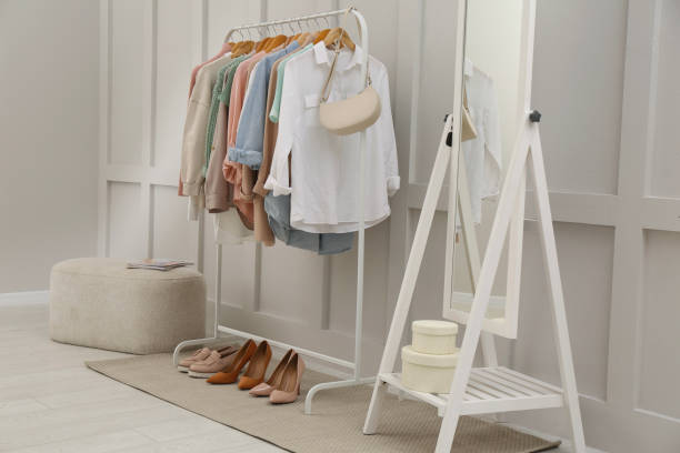 istock Rack with stylish women's clothes and mirror in dressing room 1413883851