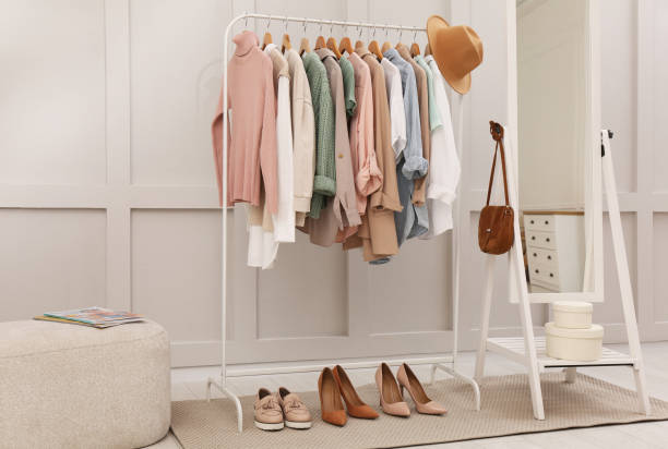 istock Rack with stylish women's clothes and mirror in dressing room 1413883900