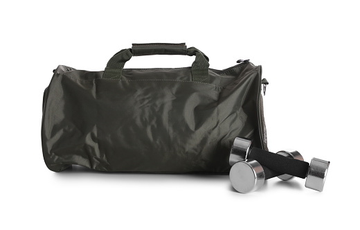 Sports bag and dumbbells on white background