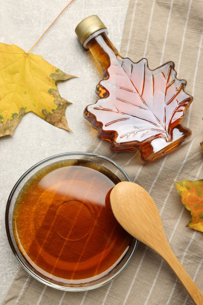 istock Flat lay composition with tasty maple syrup and dry leaves on light grey table 1413884115