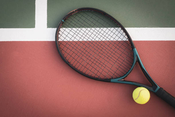 istock Racket And Ball On Tennis Field 1413884870