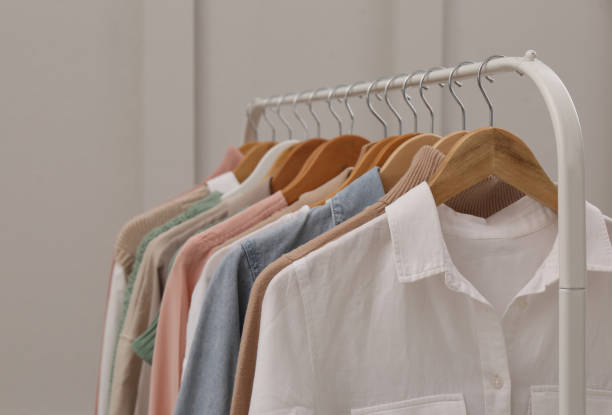 istock Rack with stylish clothes near light wall 1413885099