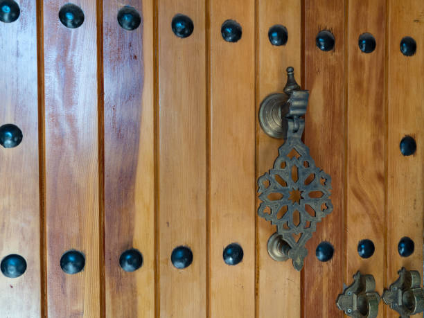 istock Ancient wooden gate. Gate with old metal handles. 1413885458