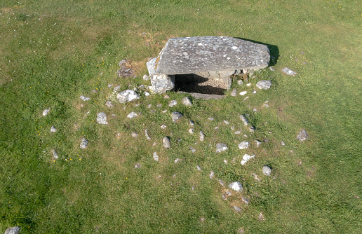 Low level aerial drone view of Nether Largie South Cairn, in Kilmartin Glen, in Argyll & Bute, on the west coast of Scotland, close to the coastal town of Lochgilphead. The burial cairn dates back 5,000 to 3,500 years and is one of the oldest prehistoric burial sites in the archeologically rich glen.