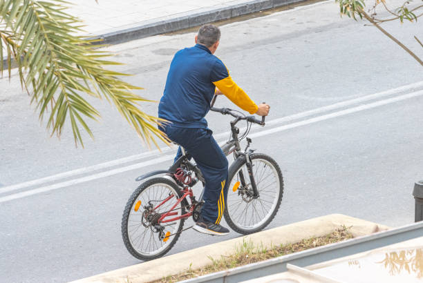 A Cyclist cycling along the main road at Rethymnon Town on Crete, Greece