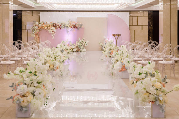 istock Wedding ceremony with rows of flowers in the hall 1413887821