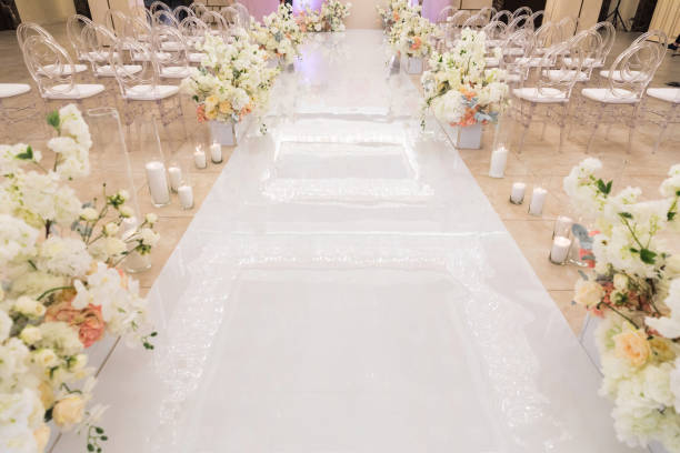 istock Wedding ceremony with rows of flowers in the hall 1413887824