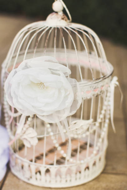 Beautiful and delicate flowers at the wedding ceremony. Flowers on a cage