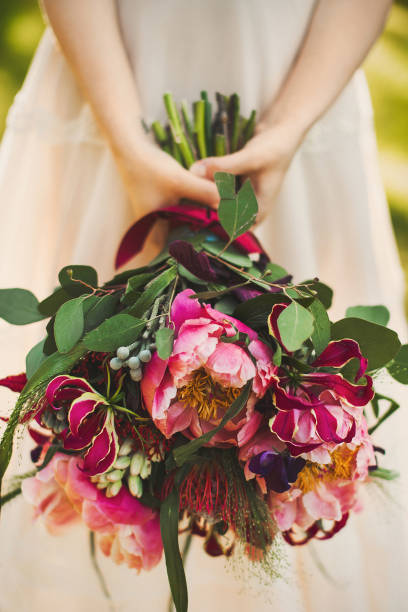 istock Bright wedding bouquet in hands of the bride 1413888484