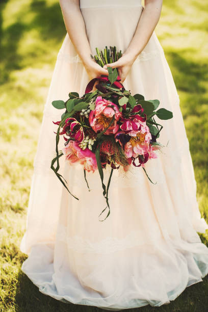 istock Bright wedding bouquet in hands of the bride 1413888496