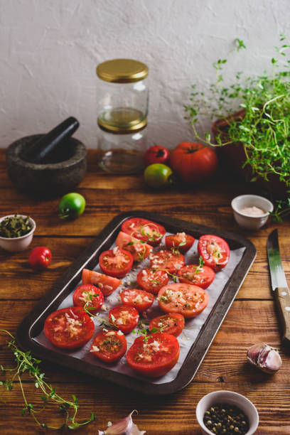 istock Sliced Tomatoes with Thyme and Garlic on Baking Dish 1413888959
