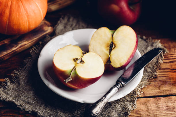 istock Two Halves of Red Apple on White Plate 1413889013
