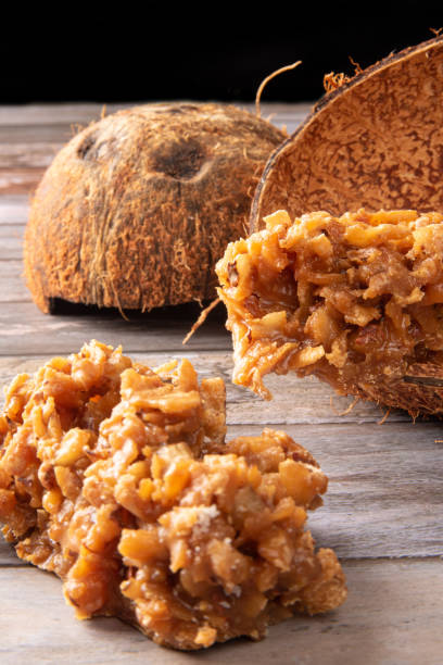 istock Cocada, Brazilian coconut-based candy arranged on a rustic wooden table, selective focus. 1413889019