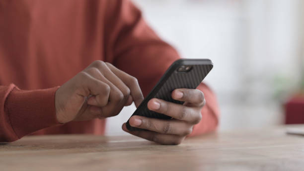 istock Hands Close up of African Man using Smartphone 1413893245