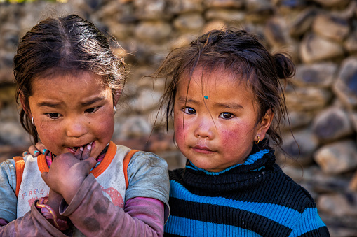 Two Tibetan young girls from small village in Upper Mustang. Mustang region is the former Kingdom of Lo and now part of Nepal,  in the north-central part of that country, bordering the People's Republic of China on the Tibetan plateau between the Nepalese provinces of Dolpo and Manang.