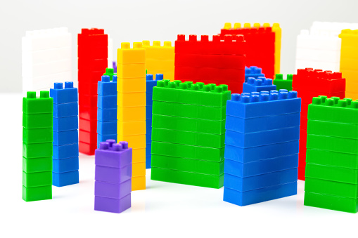 colored blocks of a plastic constructor on a white background in the form of multi-storey buildings. concept of modern buildings and houses