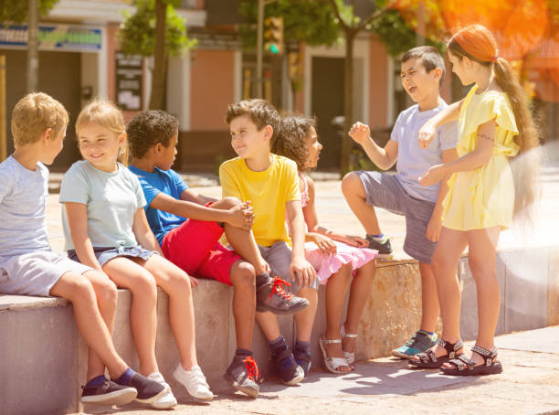 istock Group children are talking about play on walk in the park 1413899147