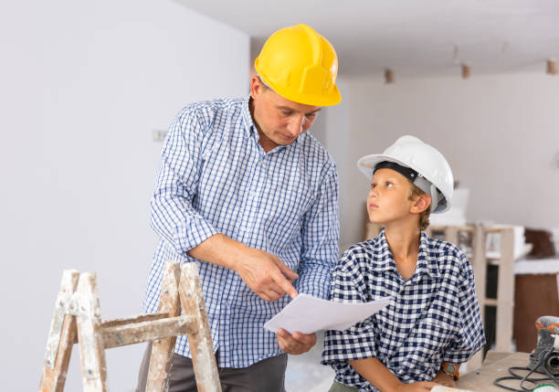 istock Father and his young son discussing work plan in construction site 1413899354