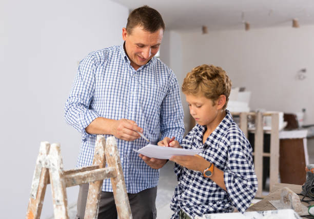 istock Father and his young son discussing work plan in construction site 1413899360