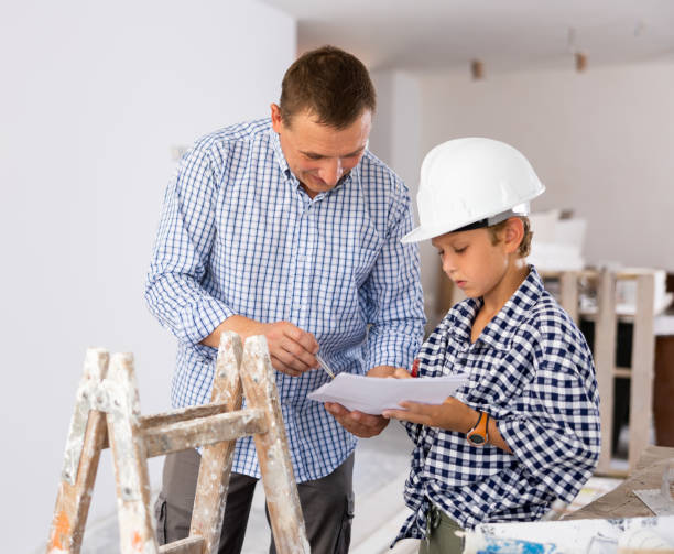 istock Father with little son talking about repair work in apartment 1413899376