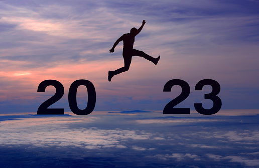 Silhouette man jumping New Years concept 2023